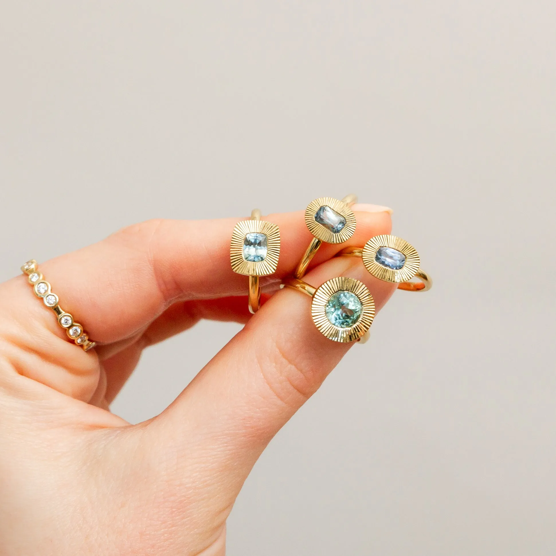East-West Cushion Aurora Ring 14KY with Light Teal Montana Sapphire