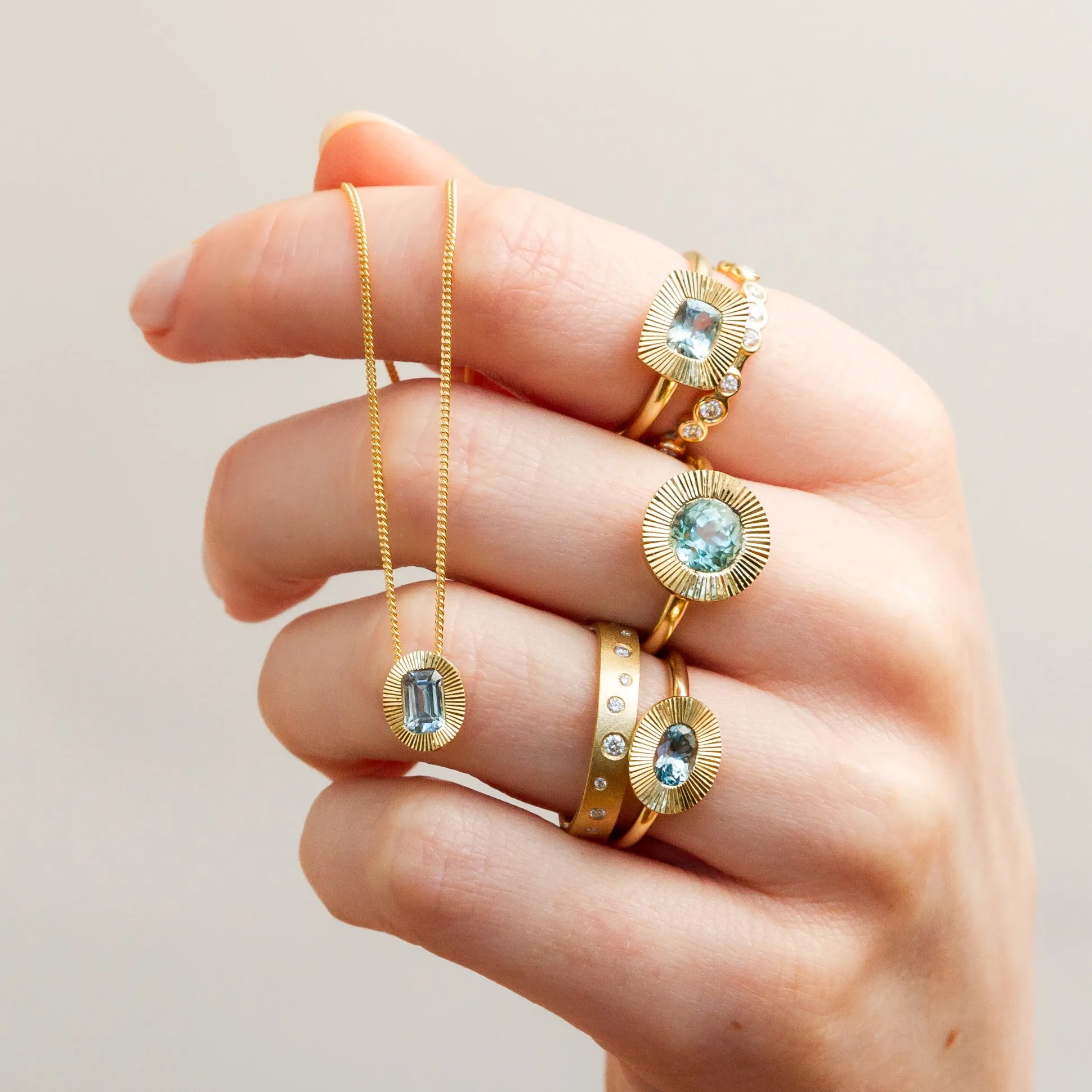 East-West Cushion Aurora Ring 14KY with Light Teal Montana Sapphire